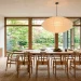 Serene Japandi style dining room featuring a light oak table, wishbone chairs, and a large paper lantern