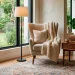 Transitional style reading nook featuring a beige chair, modern lamp, and natural light