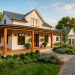 Stunning modern farmhouse exterior featuring crisp white siding and a warm cedar wood front porch.