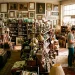 Vintage junk shop filled with antique wooden chairs, brass lamps, and hidden treasures ready for flipping