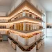 Modern grey and white pantry organization with clear canisters, woven baskets, and sleek floating shelves.