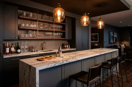 Luxurious modern home bar featuring charcoal grey cabinetry and a stunning white marble countertop.