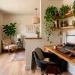 Cozy small space home office nook with wood desk and plants in a brightly lit corner