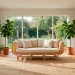 Bright living room featuring sustainable rattan furniture, cream linen cushions, and lush houseplants in natural sunlight.