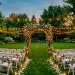 Lush backyard garden landscaped for a picture-perfect wedding ceremony with floral arch and warm lighting