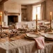 Beautifully styled rustic Valentine's Day table with layered linens, brass candlesticks, and warm lighting