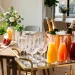 Stylish mimosa bar setup on a vintage brass cart in a sunlit modern dining room