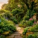Winding natural stone garden path leading through lush green ferns and vibrant hydrangeas at golden hour.