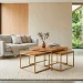 Sleek wooden and brass nesting tables in a modern sunlit living room saving space