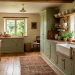 Cozy farmhouse kitchen featuring sage cabinets, open shelving, and a vintage runner rug in soft light.