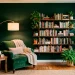 Cozy forest green reading nook with a velvet armchair, brass floor lamp, and floating wood shelves