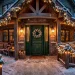 Beautifully decorated holiday porch featuring weatherproofed garlands, glowing string lights, and snow-dusted steps at dusk.