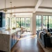High-end kitchen featuring custom cabinetry with luxury brushed brass hardware and gold faucet accents.