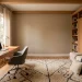 Modern multi functional guest room office combo featuring a stylish oak desk and a sleek built in Murphy bed.