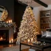 Sophisticated holiday living room featuring a glowing Christmas tree with moody charcoal and silver decorations.
