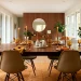 Mid-century modern dining room decorated for Thanksgiving with a walnut table and brass accents
