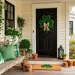 Beautifully decorated front porch for St. Patrick's Day featuring green pillows and a shamrock wreath