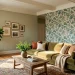 Elegant living room featuring sage green paint perfectly coordinated with botanical wallpaper.