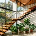 Wide view of a mid-century modern staircase featuring floating teak treads and black steel stringers.