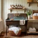 Restored vintage cast iron utility sink in a sunlit farmhouse laundry room styled with fresh white linens.