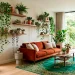 Sophisticated modern living room with lush botanical decor featuring an olive tree and trailing pothos vines.