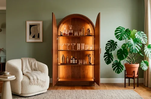 Walnut arched home bar cabinet in a modern living room with soft lighting