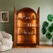 Walnut arched home bar cabinet in a modern living room with soft lighting