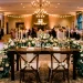 Elegant wedding sweetheart table with cascading floral runner and flickering taper candles