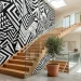 Modern staircase with a large black and white geometric mural on the wall, wooden treads, and sleek glass railing.