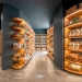 Wide horizontal view of a perfectly organized modern slate grey deep pantry with wood shelves and clear bins.