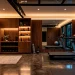 Luxurious home fitness room featuring rich dark walnut cabinetry and sleek workout equipment
