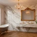 Luxurious Parisian chic bathroom featuring Calacatta marble walls, a freestanding tub with gold claw feet, and vintage brass fixtures.