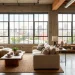 Spacious industrial loft living room with concrete walls, plush linen seating, and warm raw wood textures bathed in sunlight.