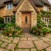 Beautiful rustic cottage exterior with a stone paved porch at golden hour