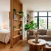 Bright and stylish small studio apartment featuring clever space-saving furniture and natural light pouring in