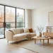 Bright clean January interior featuring white oak floors, white walls, and a cozy cream sofa with wooden legs