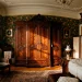 Large ornate dark mahogany wardrobe in a traditional Victorian bedroom
