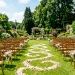 Beautiful outdoor wedding ceremony aisle decorated with simple and elegant floral arrangements