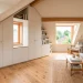 Beautifully renovated attic space featuring custom built-in white cabinets under sloped ceilings.