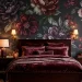Luxurious moody bedroom featuring dark floral wallpaper and velvet bedding