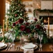 Wide horizontal banner of a DIY floral holiday decor centerpiece on a festive dining table.