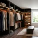 Organized walk-in closet showcasing a mix of velvet and wooden hangers holding a capsule wardrobe to save space.