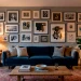 A beautifully styled living room featuring an eclectic gallery wall with mixed frames over a velvet sofa