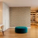 Wide view of a modern dressing room featuring geometric wallpaper and luxury built-in wardrobes