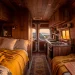 Cozy camper van interior featuring warm golden hour lighting and wood cabinets