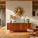 Wide view of a mid-century modern living room featuring sleek walnut furniture and geometric brass wall art.