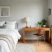 Bright modern guest room office combo with cozy bed and sleek wooden desk