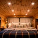Finished camper van interior with a beautiful rustic tongue-and-groove wood ceiling and warm lighting