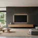 Modern minimalist living room with a wire-free wall-mounted TV and floating console.