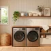 Modern laundry room with a custom wood countertop over front-loading machines